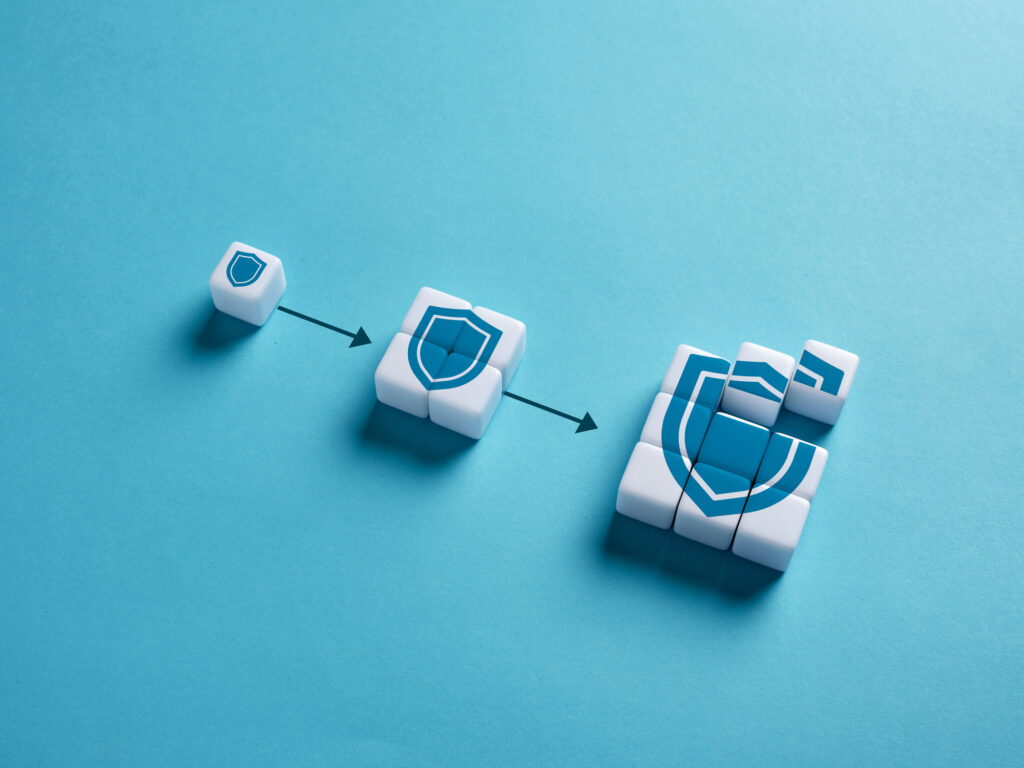 Cubes form a row of increasingly larger cybersecurity shields.